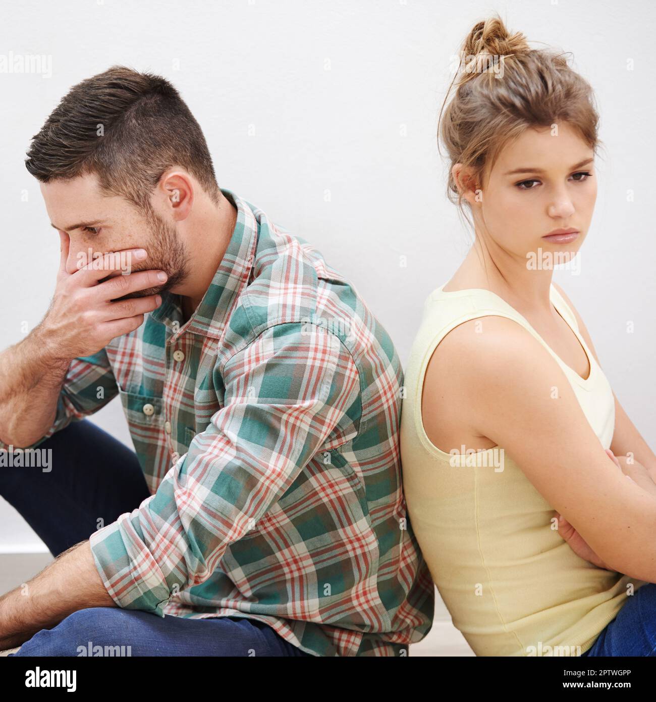 Theyve reached a stalemate. a young couple having relationship difficulties sitting back to back Stock Photo