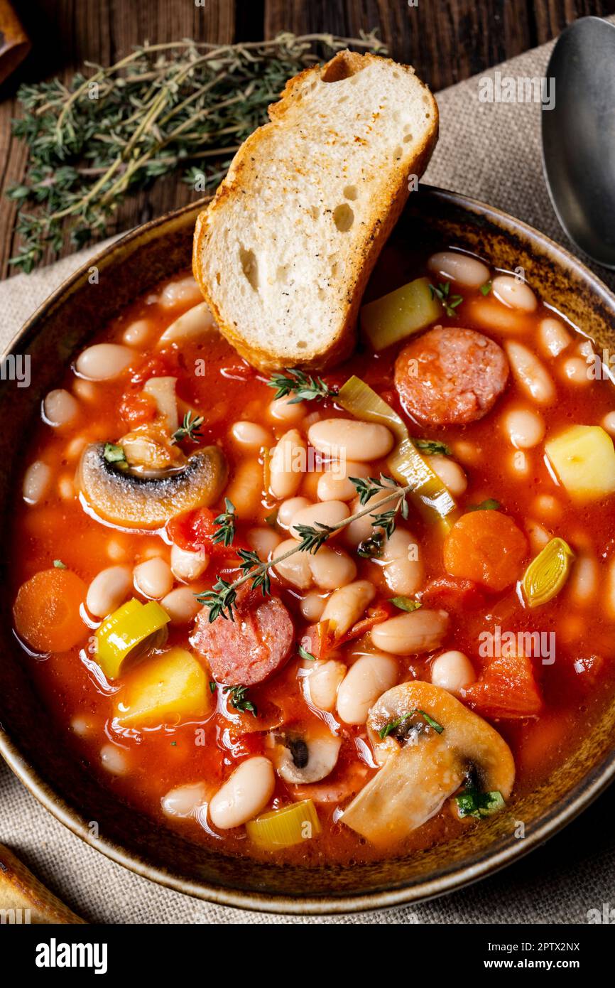 rustic bean soup with potatoes and sausages Stock Photo - Alamy