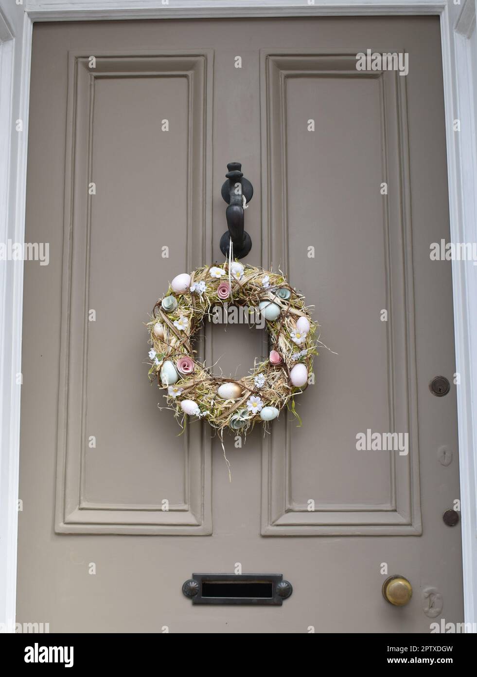 Easter wreath hanging on a door. Stock Photo