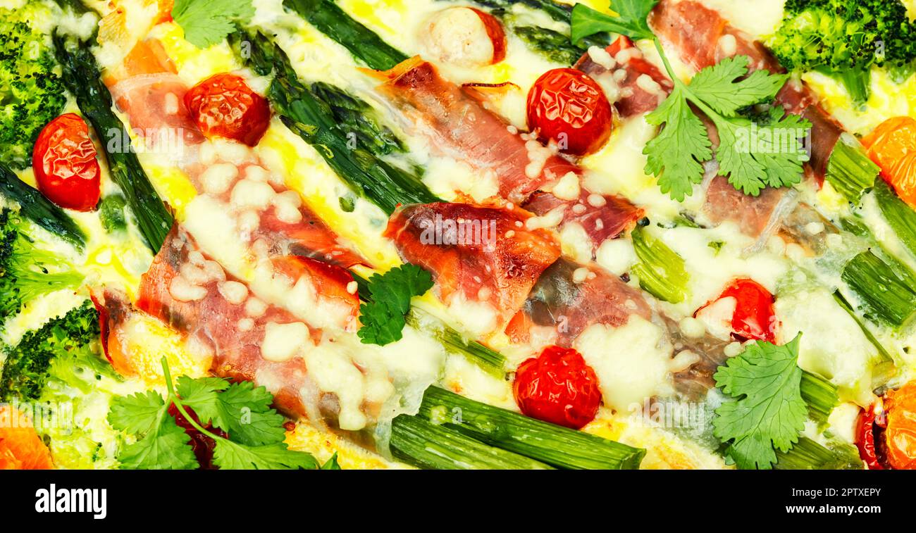 Asparagus wrapped in bacon with grated parmesan cheese.Food background