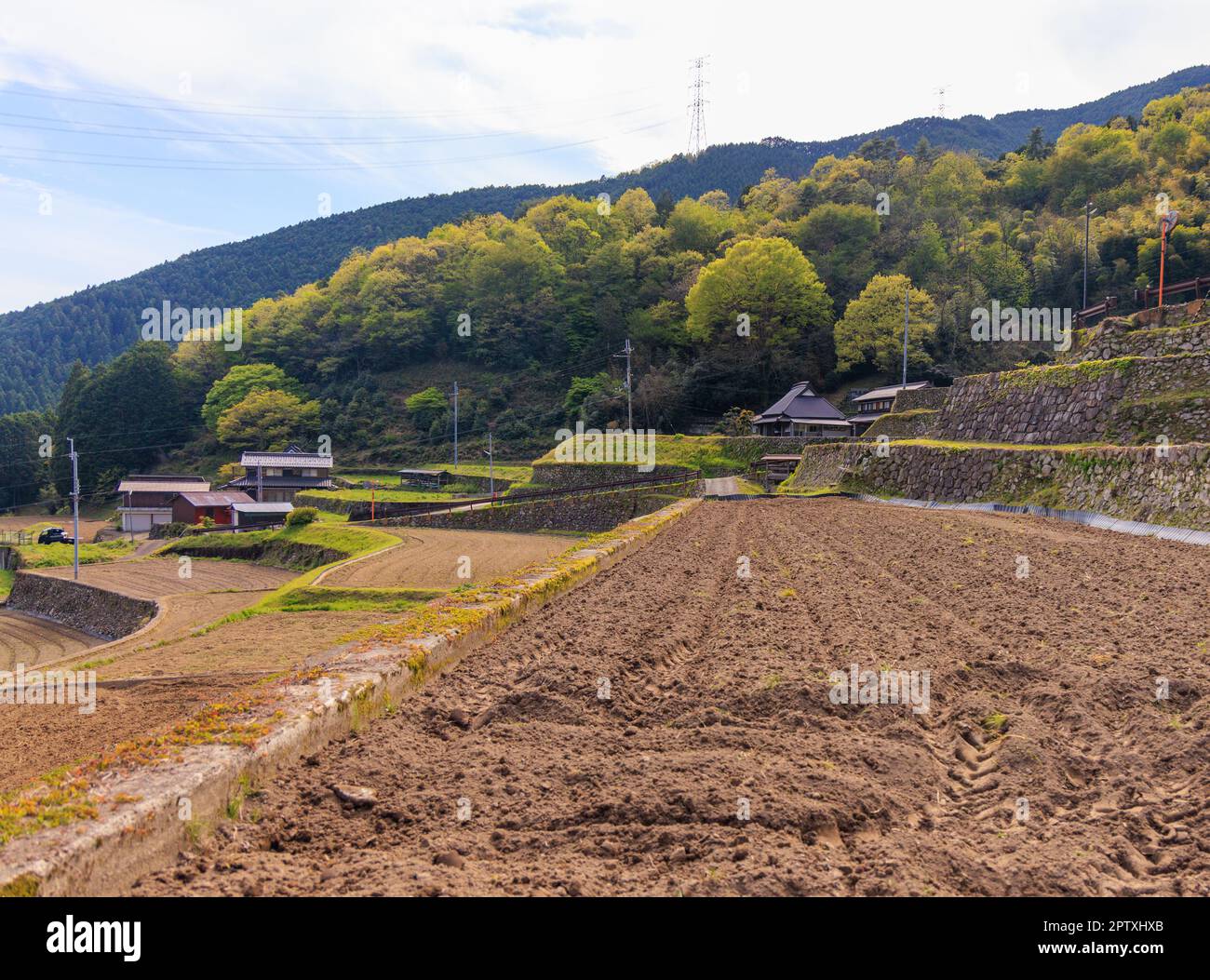 Freshly plowed soil on terraced rice field in traditional Japanese