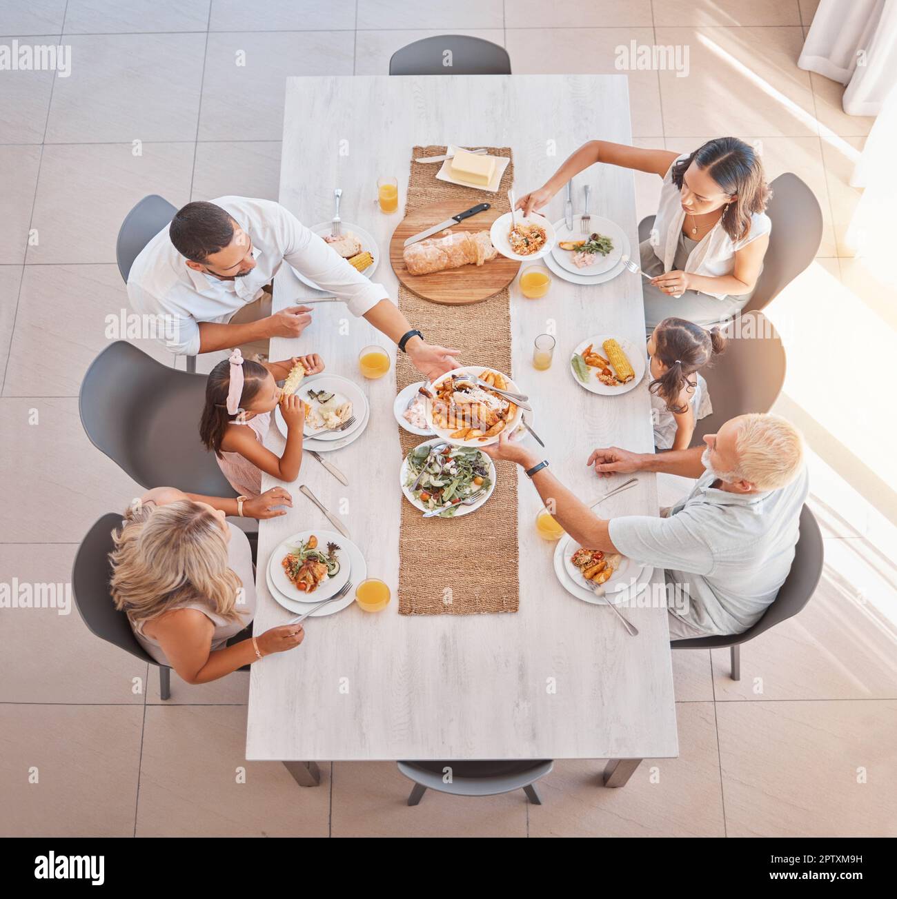 Family, lunch and food at the table with big family bonding, sharing