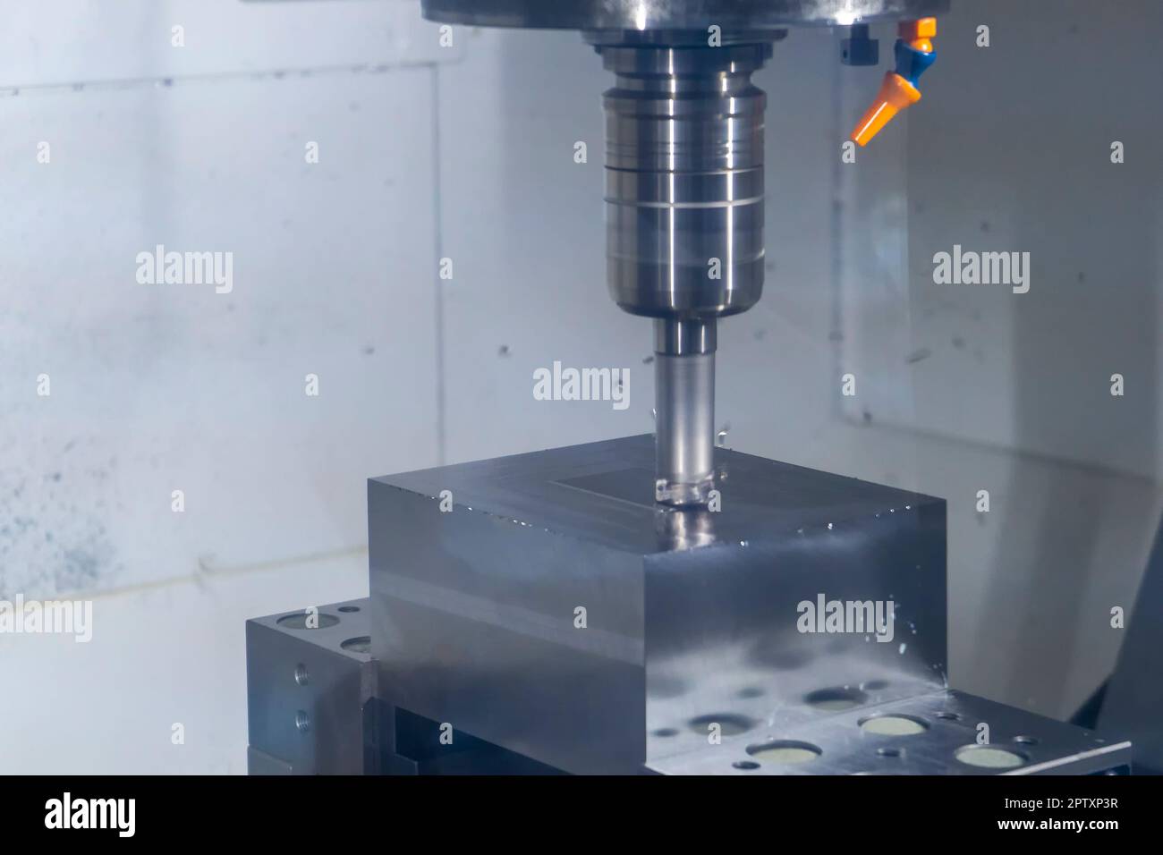 CNC machine tool cutting raw material in factory Stock Photo
