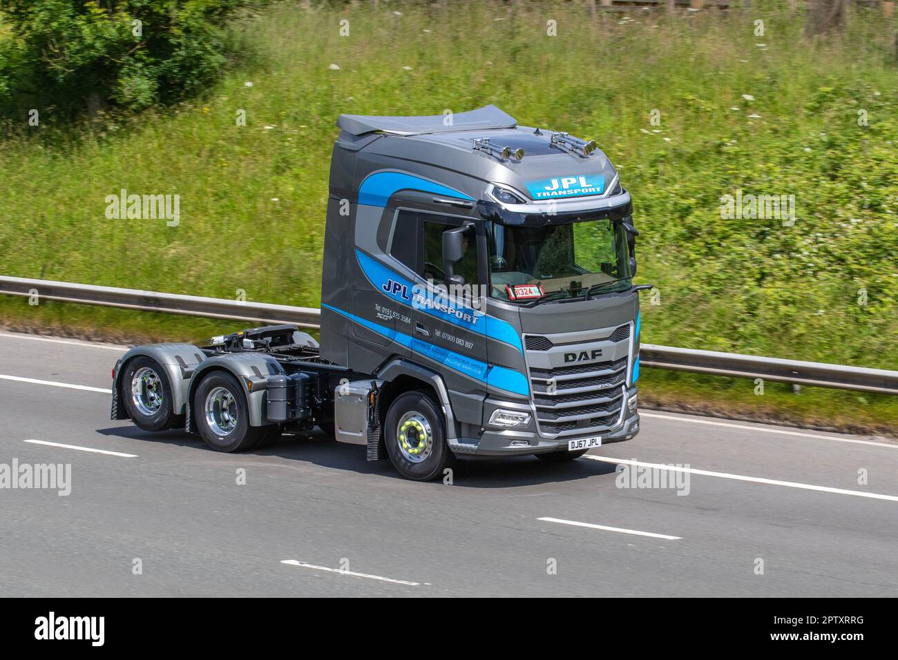 2023 Grey Blue Daf CF 330 6x2 10 Tyre Rear Lift Sleeper Cab Tractor Unit with trade plates; DAF CF 330 Euro 6 sleeper cab, 6x2 rear lift; travelling on the M61 motorway, UK Stock Photo