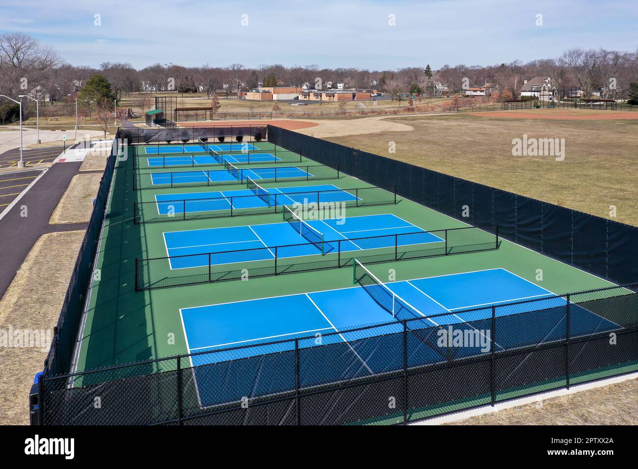 Aerial view of a new pickleball facility complex with blue and green