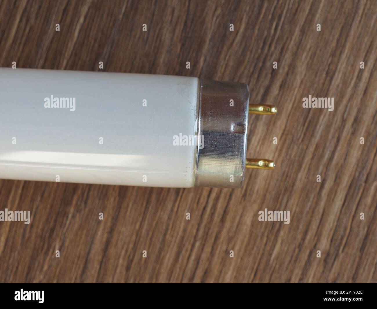 fluorescent tube light bulb over wooden desktop Stock Photo Alamy