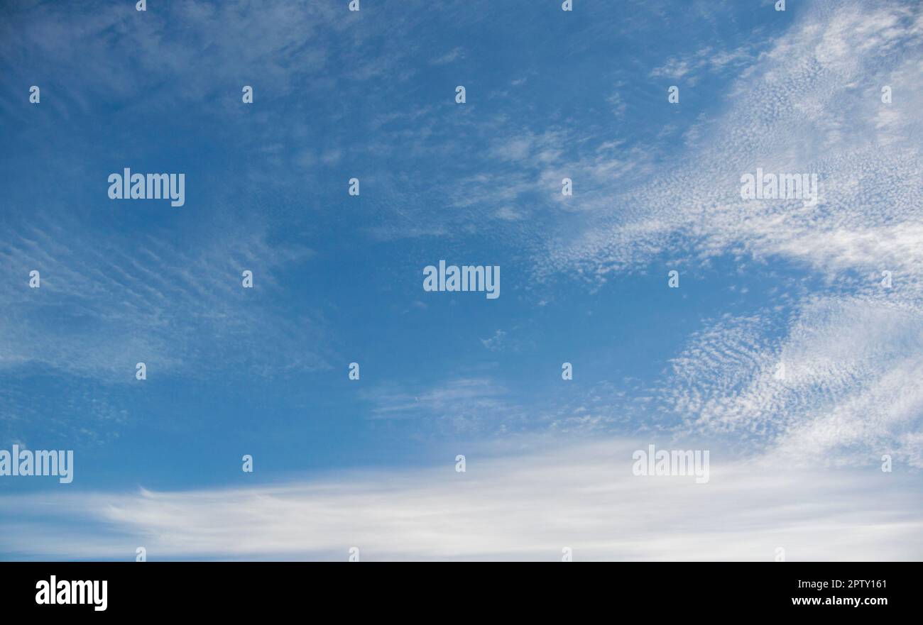 White clouds against a blue sky Stock Photo - Alamy