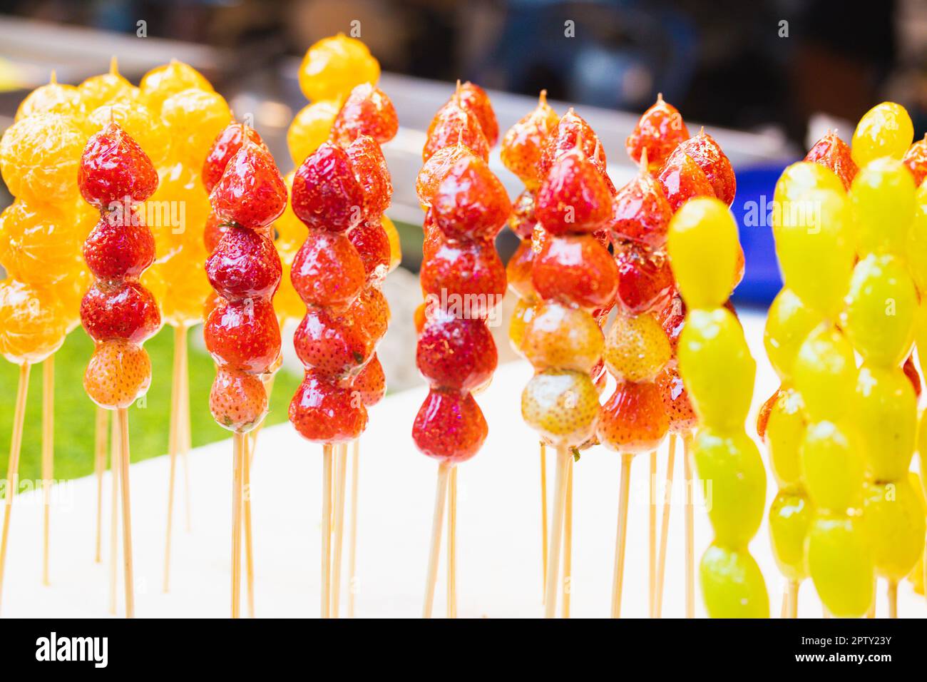 Skewers of sugarcoated fruit Stock Photo Alamy