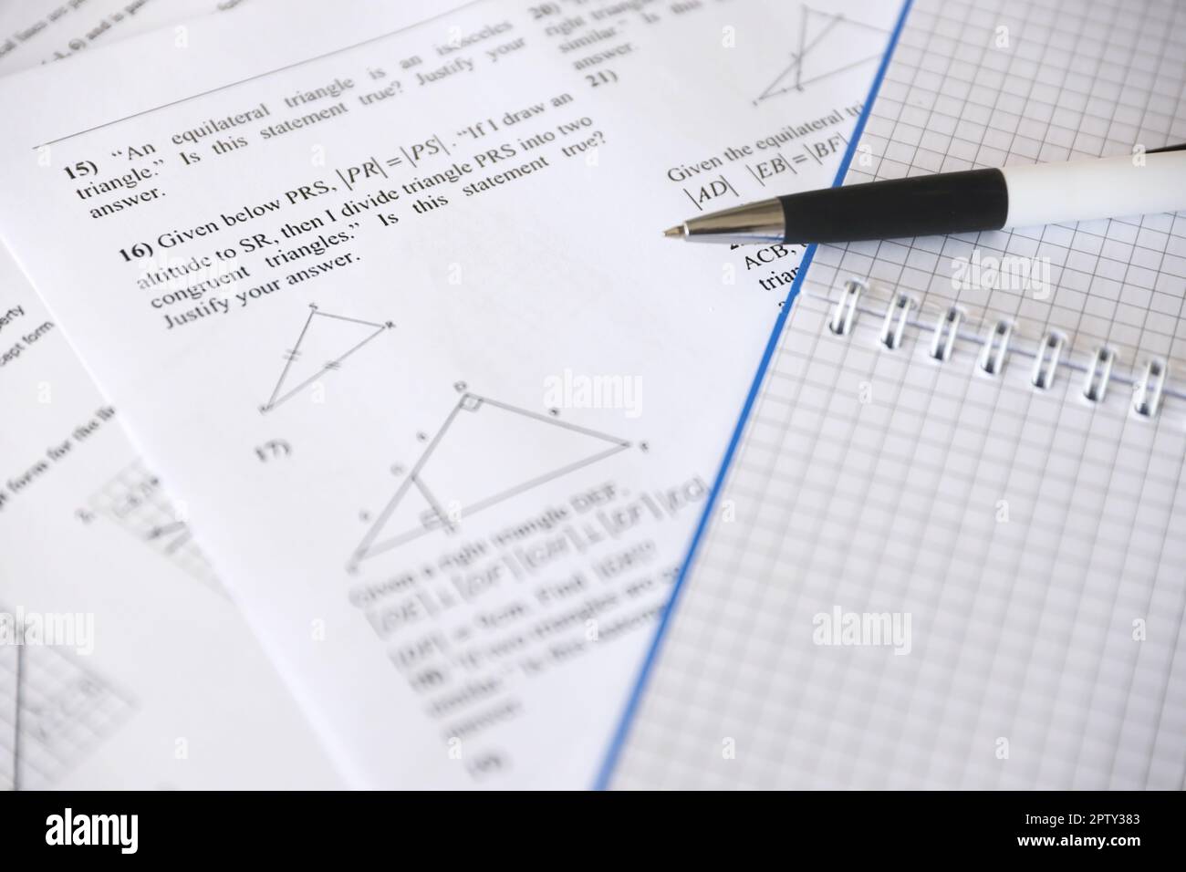 Handwriting of geometrical tasks on examination, practice, quiz or test in geometry class. Solving exponential equations background concept. Stock Photo