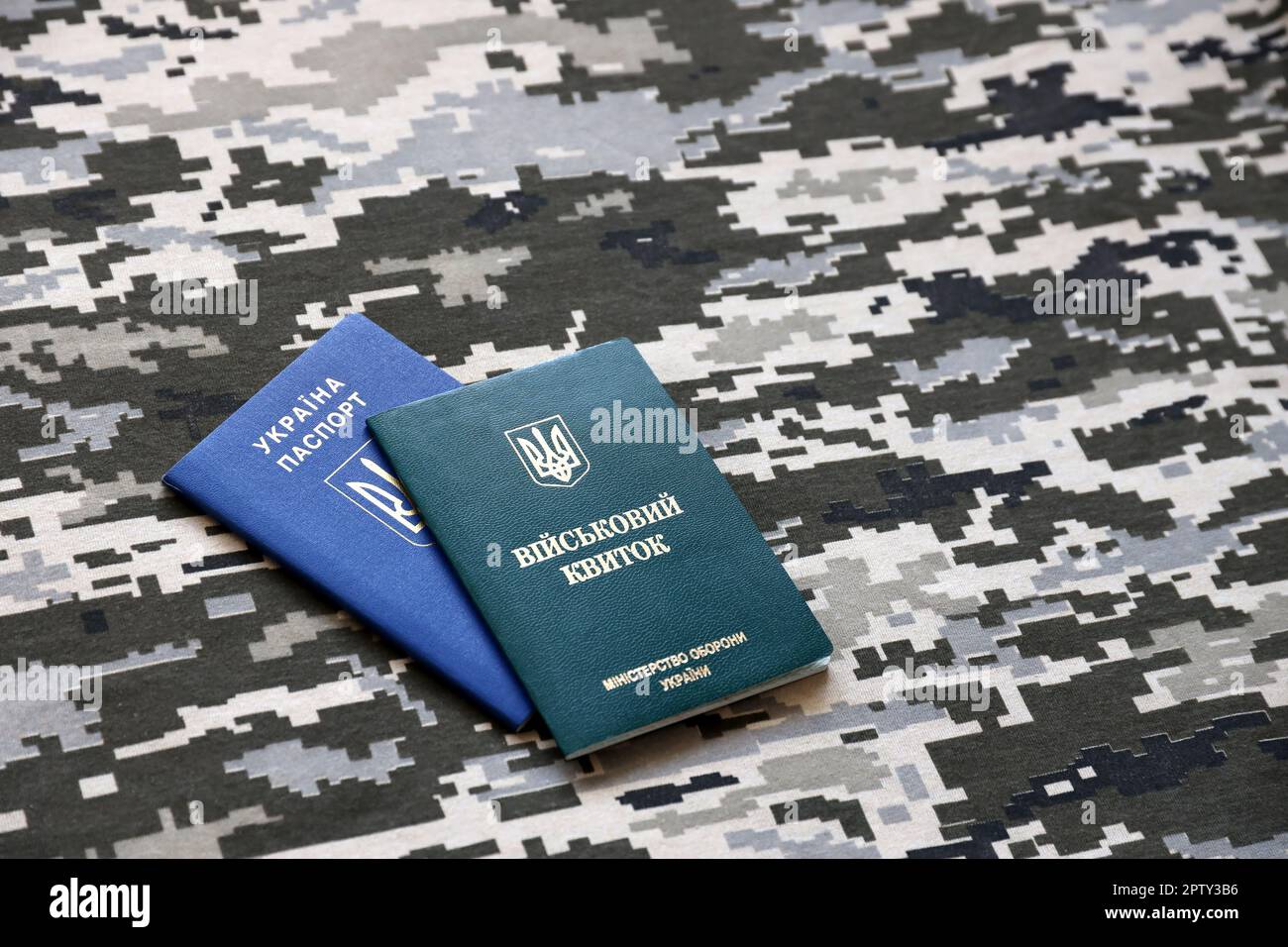 Ukrainian military ID and foreign passport on fabric with texture of