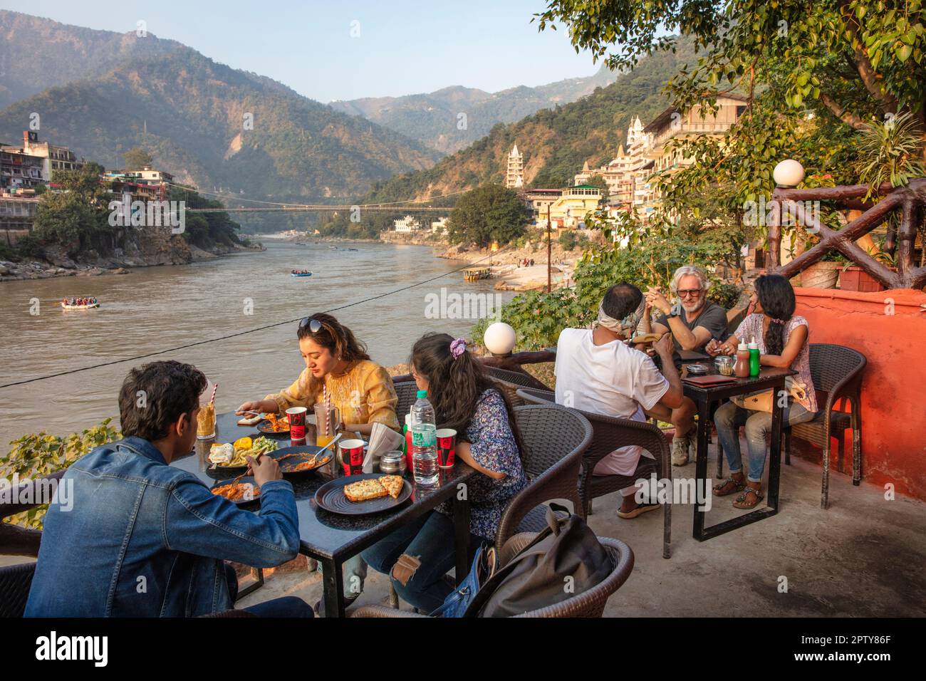 India, Uttarakhand, Rishikesh, Ganga, Ganges river. Lakshman Jhula bridge. Outdoor cafe. Stock Photo