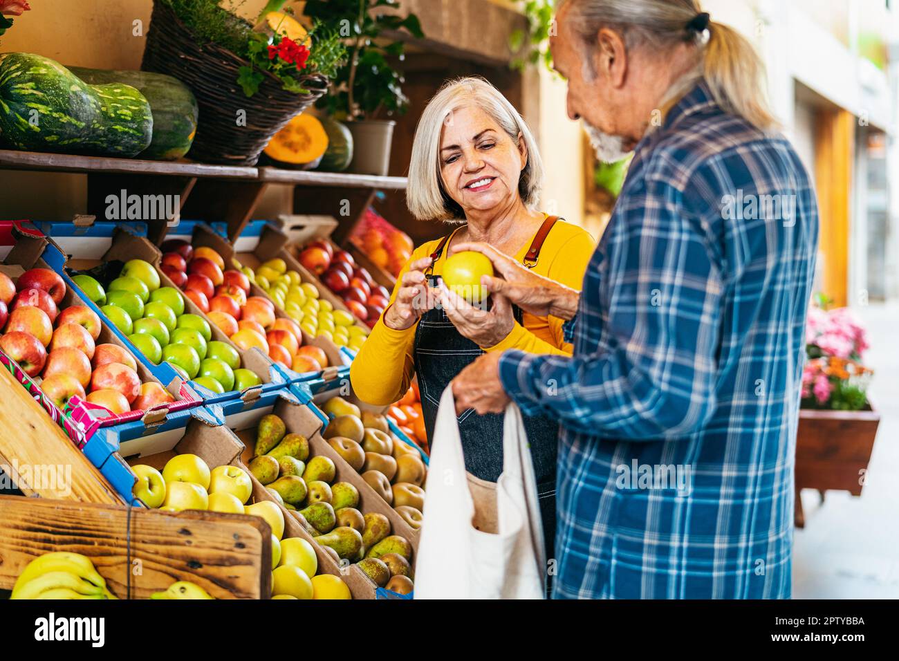 Senior man buying fresh fruits at the market - Shopping food concept Stock Photo