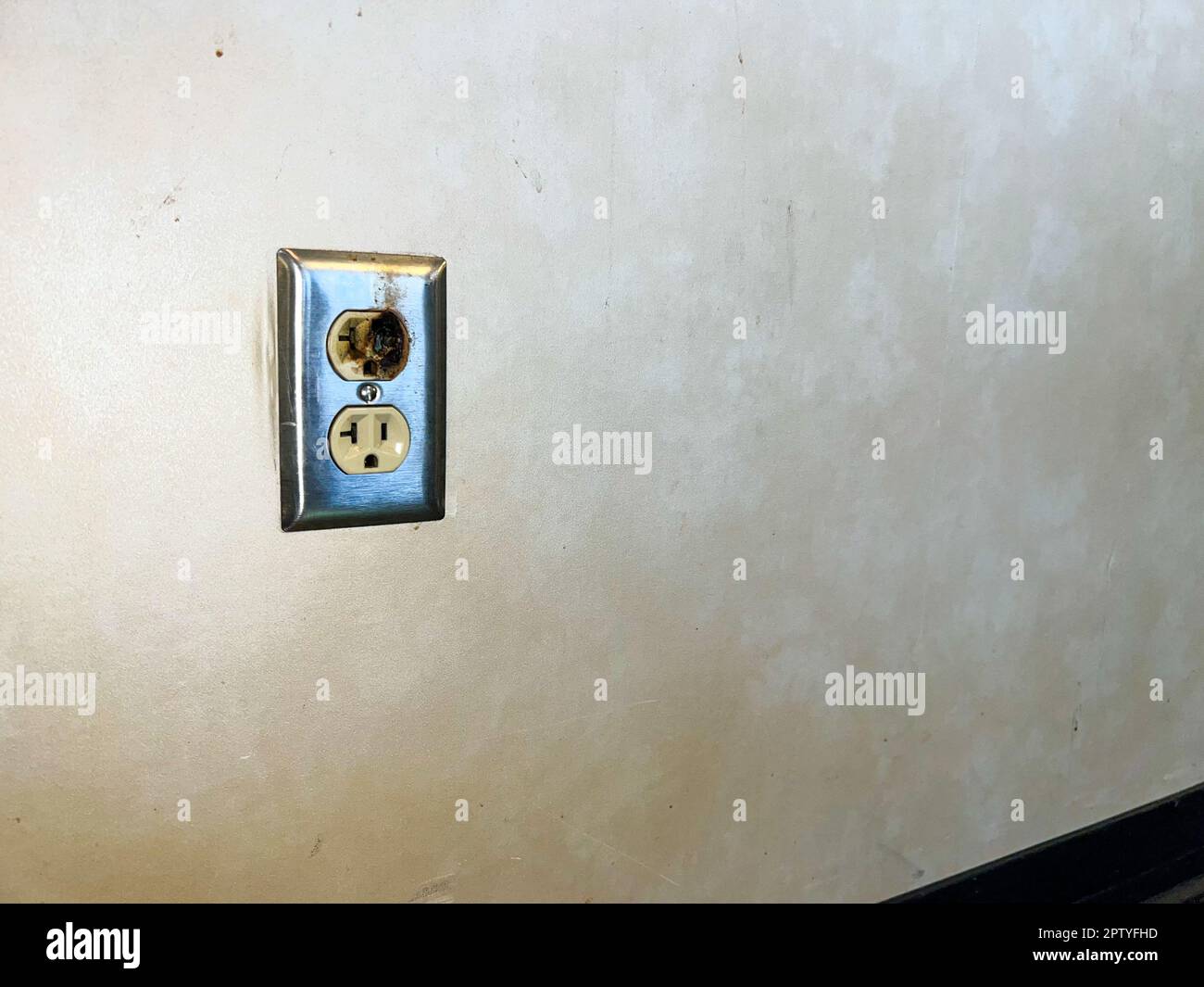 Faulty burned electrical outlet with copy space Stock Photo