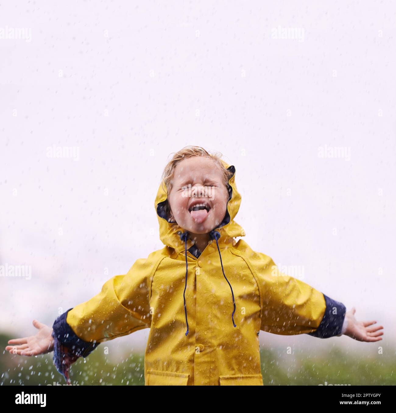 Dancing in the rain. an adorable little girl playing outside in the rain  Stock Photo - Alamy