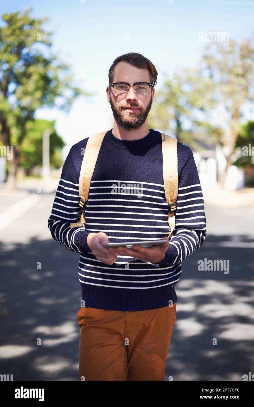 The epitome of geek meets hip Meet the modern hipster. A handsome young hipster outdoors while wearing glasses Stock Photo