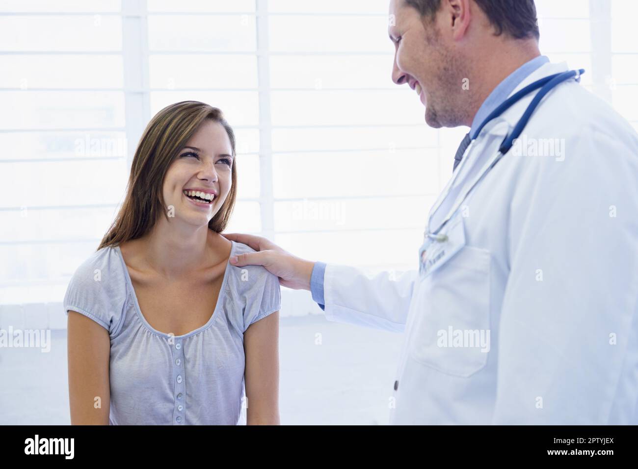 Youre in excellent health. A young woman looking relieved during a visit to the doctor Stock Photo
