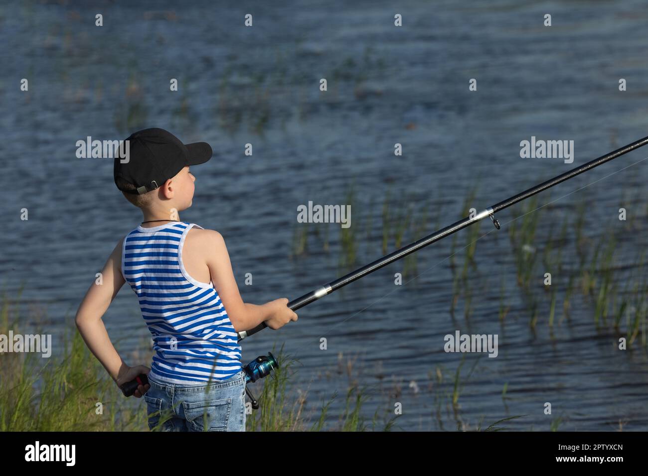Boy fishing on small lake hi-res stock photography and images - Alamy