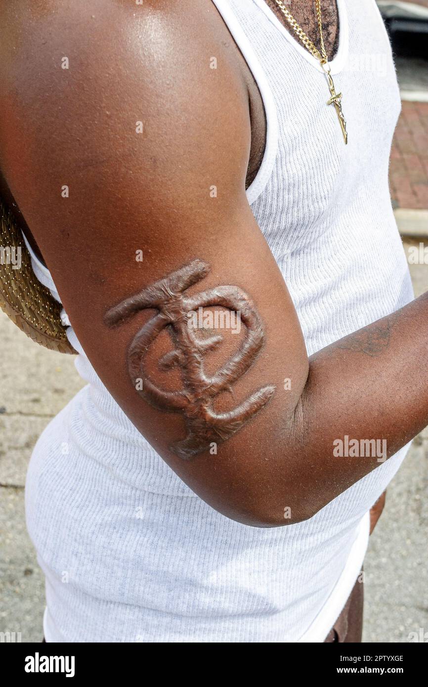 Miami Florida,Coconut Grove Bahamian neighborhood,Black man men male,arm branded fraternity symbol Stock Photo