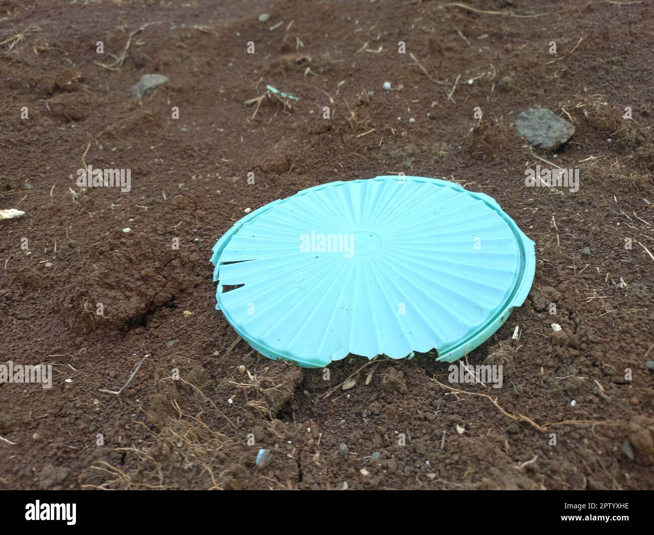 As a result of an unhealthy environment, there is waste of jar lids thrown carelessly on barren land, in bogor Stock Photo
