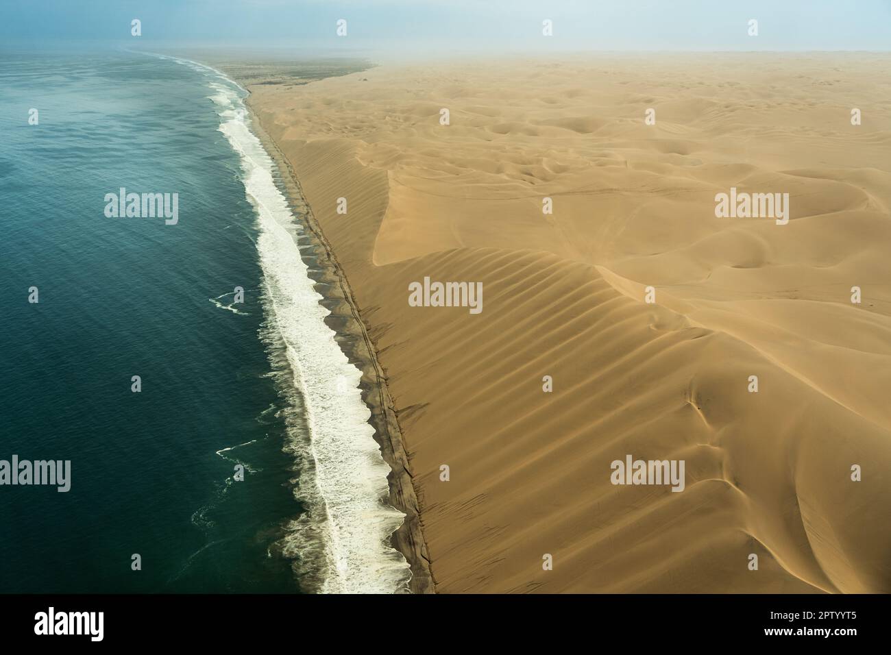 Aerial photography of flight over the dunes that meet the Atlantic Ocean Namibia Stock Photo