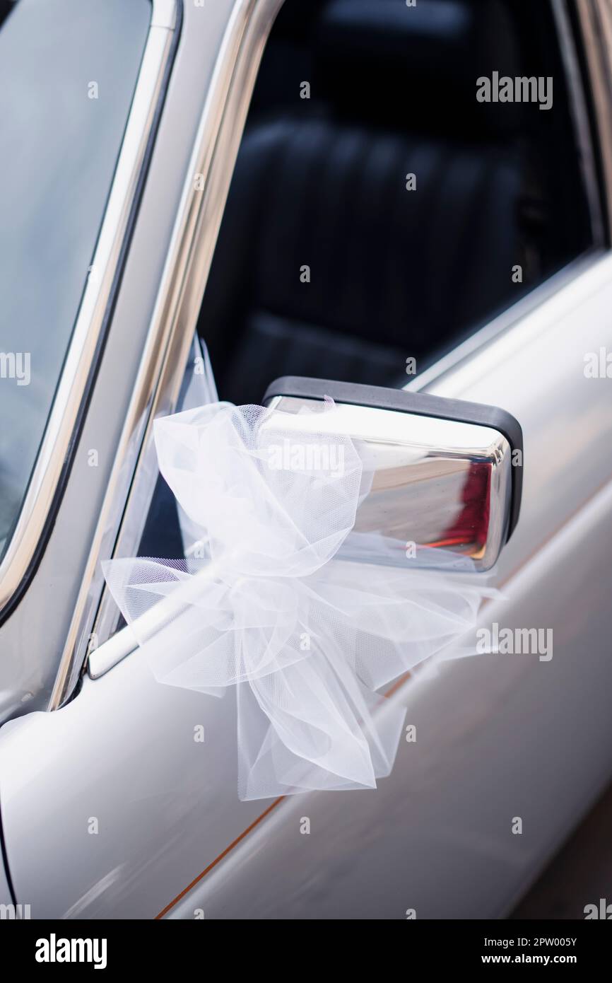 White ribbon wedding decoration on a vintage car side mirror Stock ...