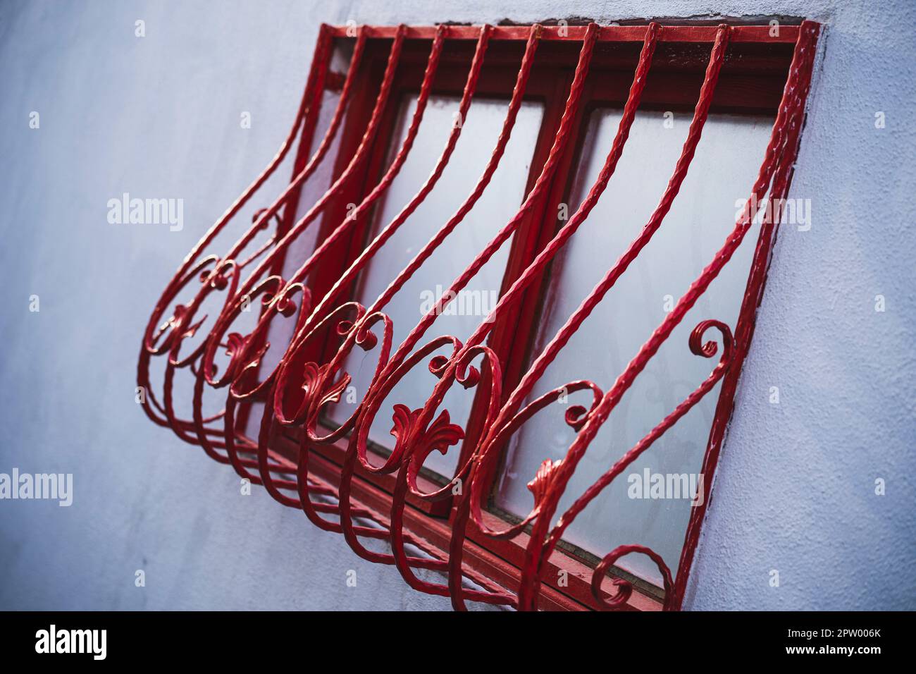 Window with red decorated bars made of forged iron Stock Photo - Alamy