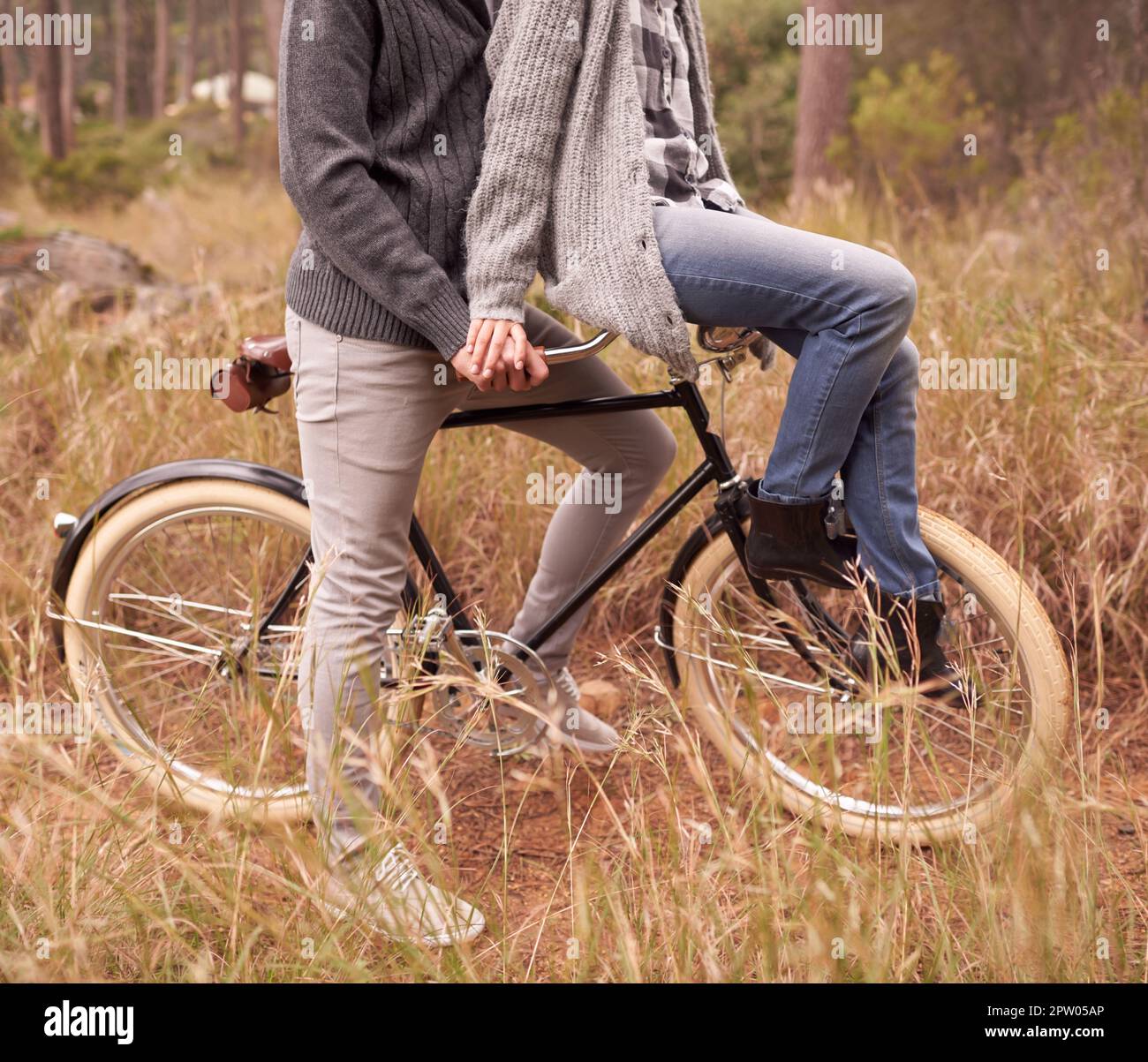 Retro dating. a young girl sitting on the handlebars of her boyfriends