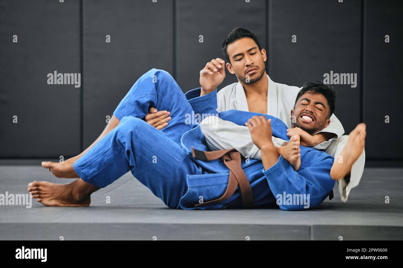 Men fighting in karate competition, coach training student at fitness