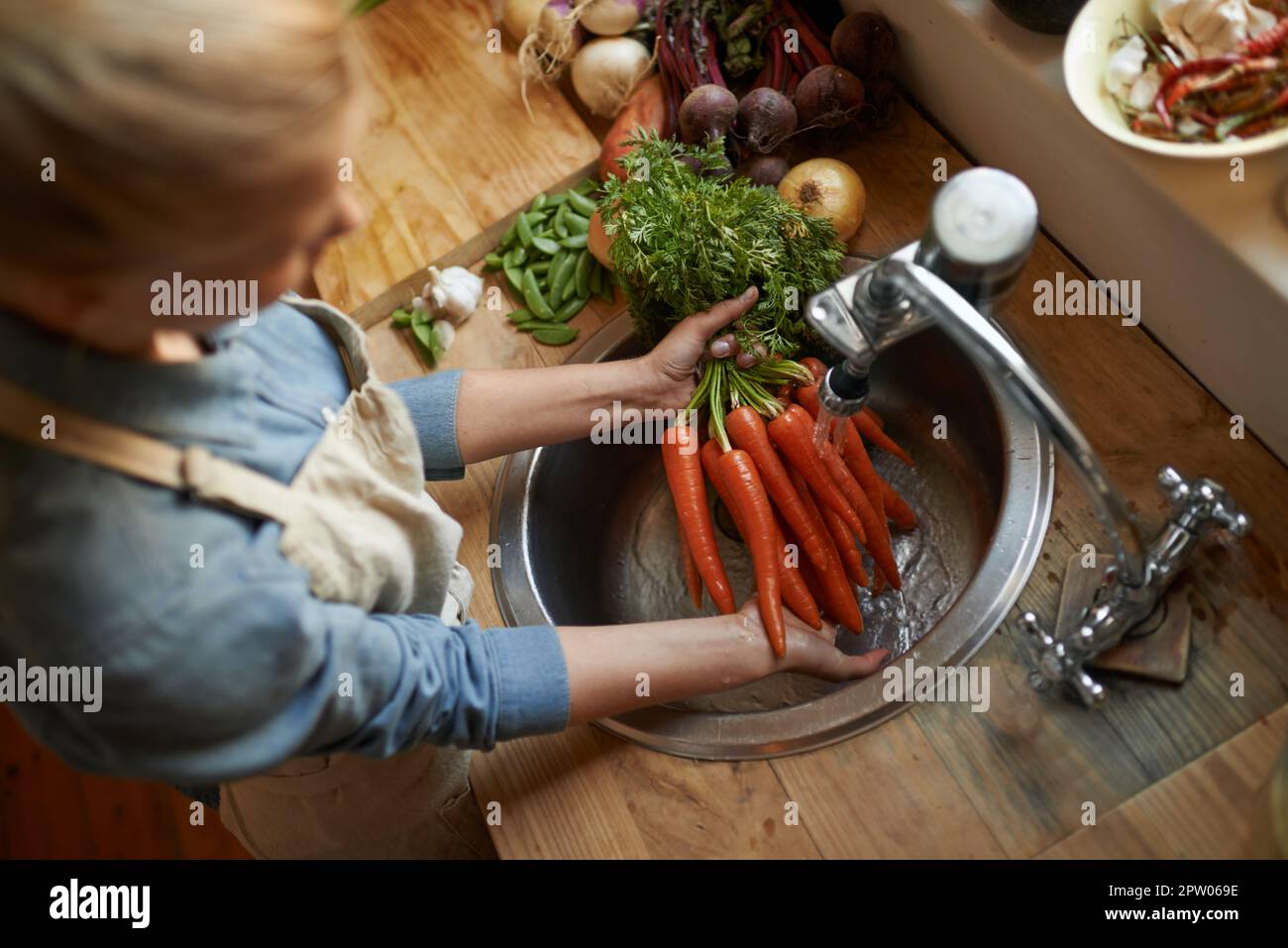 Washing them off before its time to cook. High angle shot of a woman