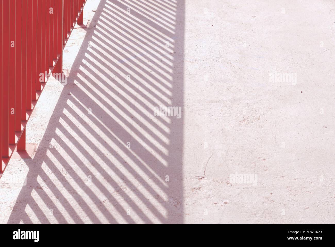 Morning Railing Shot Abstract shot of an orange railing casting its shadow over a plain ...