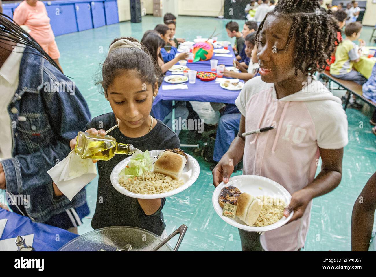 Miami Florida,Frederick Douglass Elementary School campus primary,inner city school cafeteria picnic lunch,student students girl girls female Black Af Stock Photo