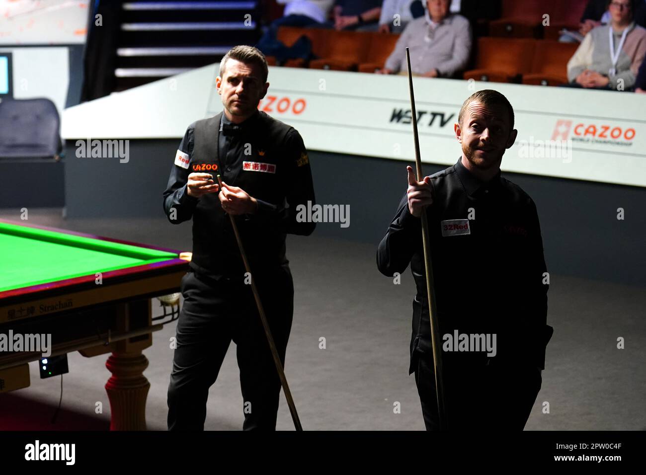 Mark Allen and Mark Selby (left) discuss the score during their match on day fourteen of the Cazoo World Snooker Championship at the Crucible Theatre, Sheffield