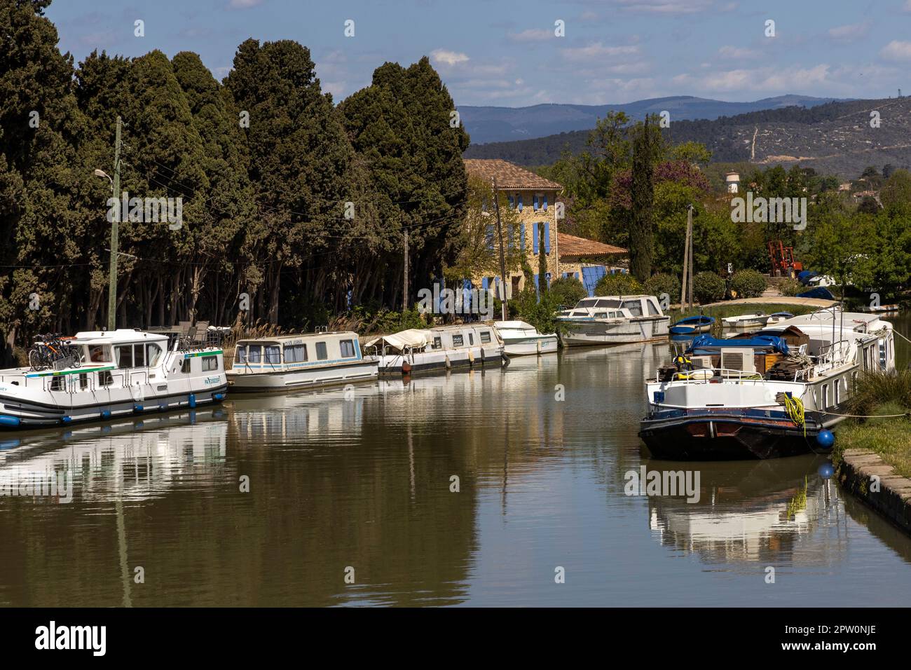 Boats moored on the Canal du Midi near the village of Bize-Minervois in the Aude department Stock Photo