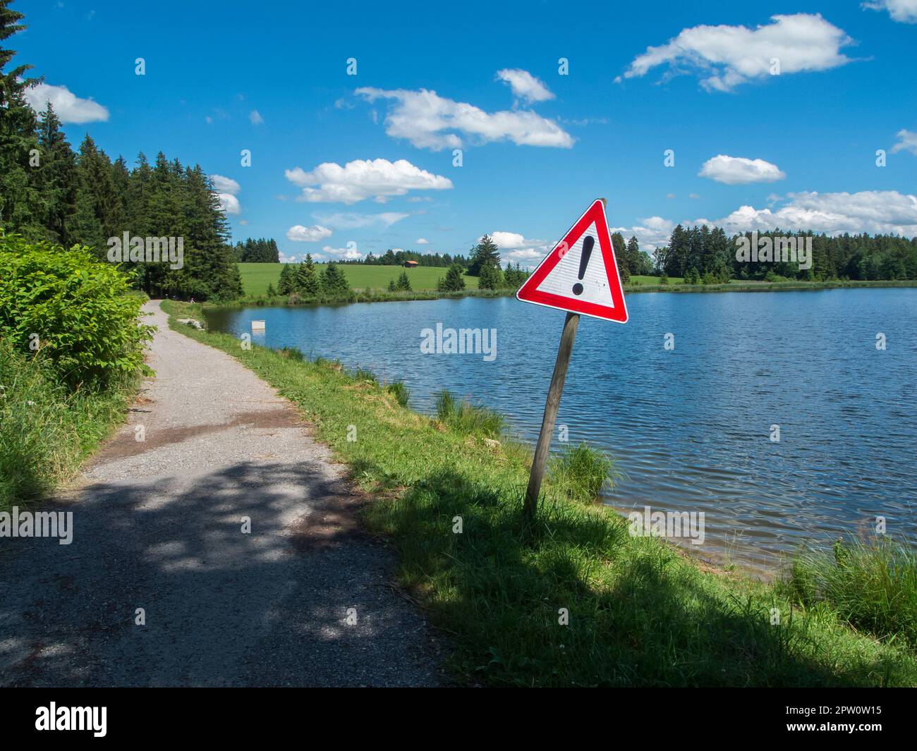 Road sign at the edge of the Pond Koegel in summer with a blue sky and small white clouds. Stock Photo