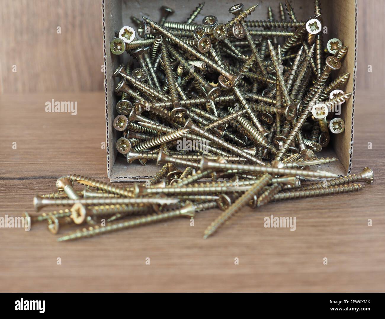 wood screws in a box on melamine manufactured wood panel Stock Photo Alamy