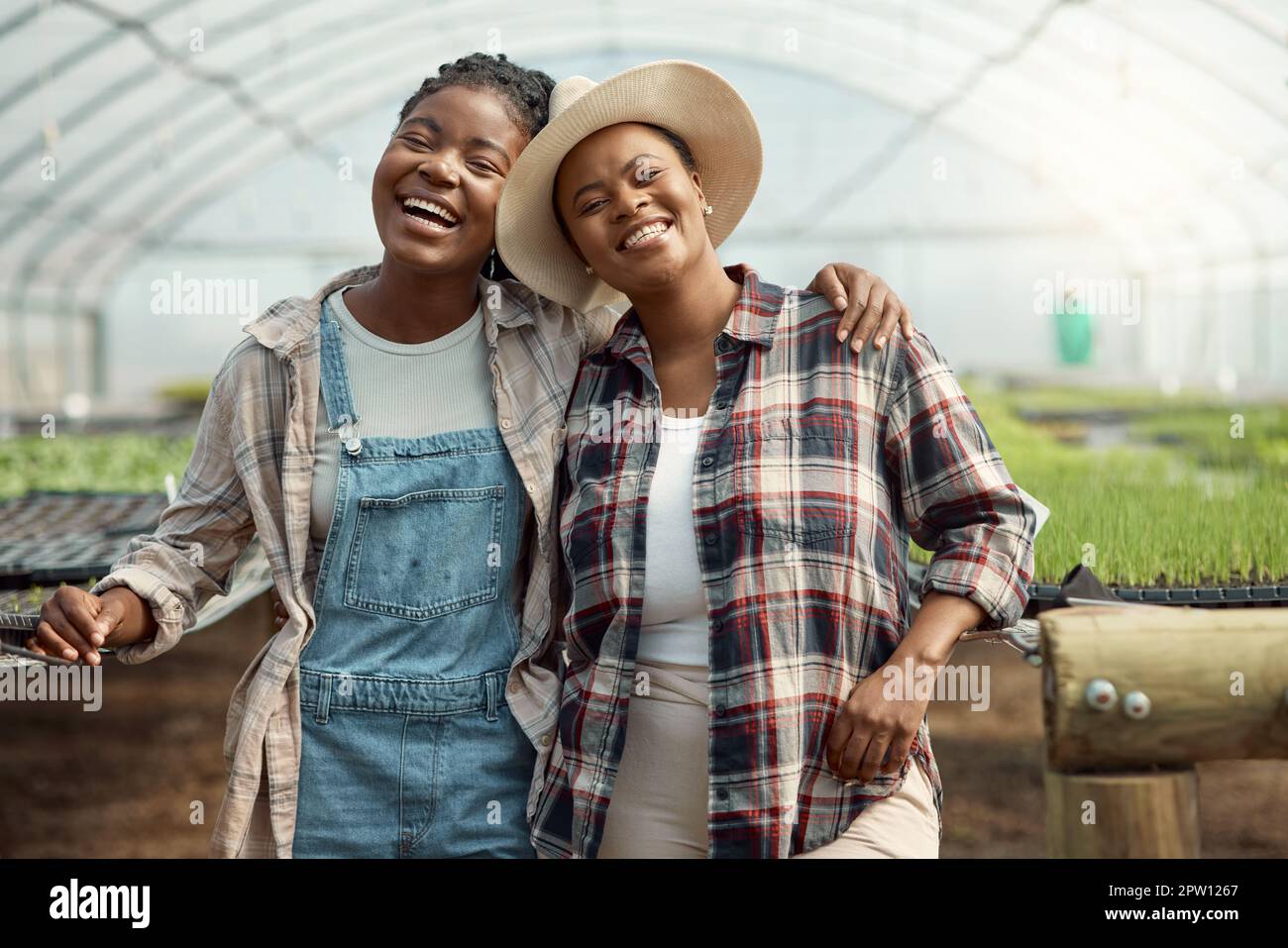 Portrait of two happy farmers. Young farmers hugging one another