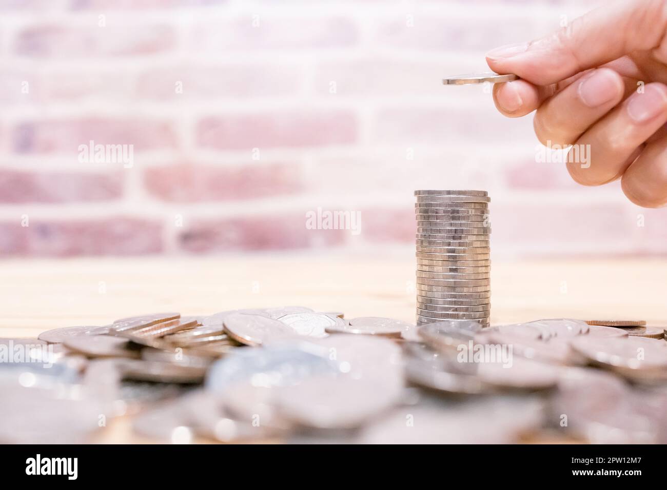 Images of growing stacking coins and Hand holding coin for planning step up and savings, Saving money for future plan and retirement fund concept. Con Stock Photo