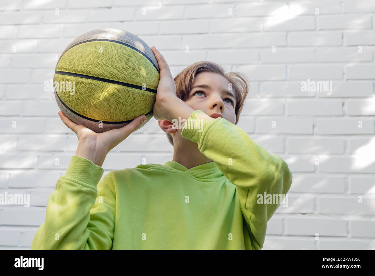 A teenager throwing a basketball into the hoop Stock Photo Alamy