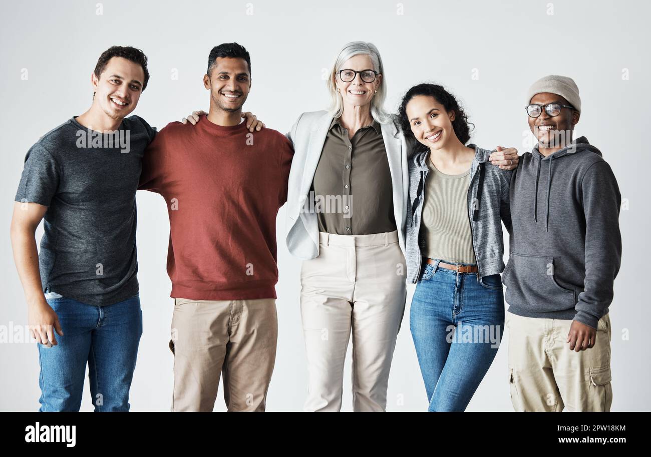 Group portrait of diverse young women wearing clothes in hipster style  looking at each other with smiles and hugging together stock photo