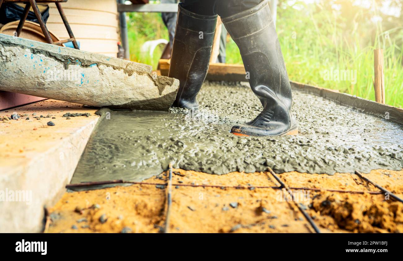 Construction worker pour wet concrete at construction site. Construction worker working with