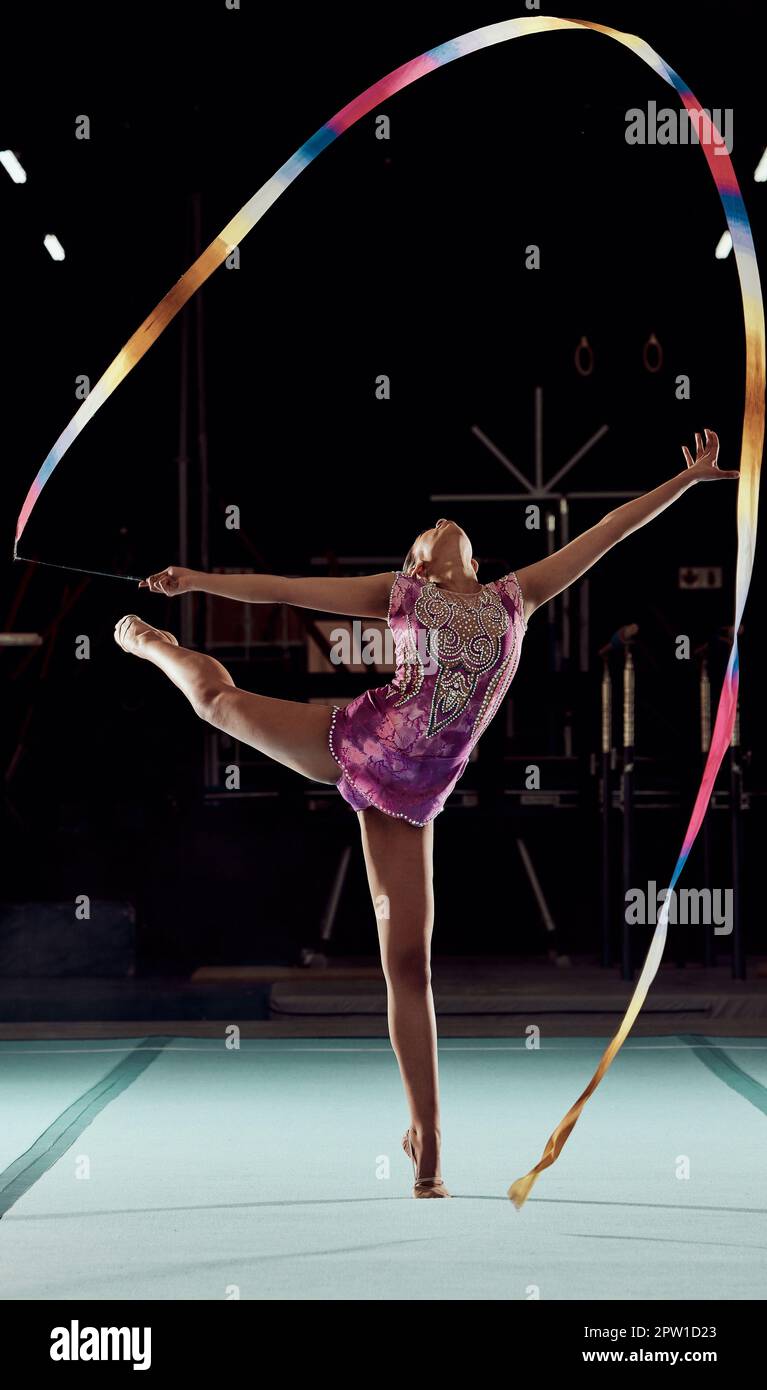 Ribbon gymnastics, exercise and sports girl performing a routine in a