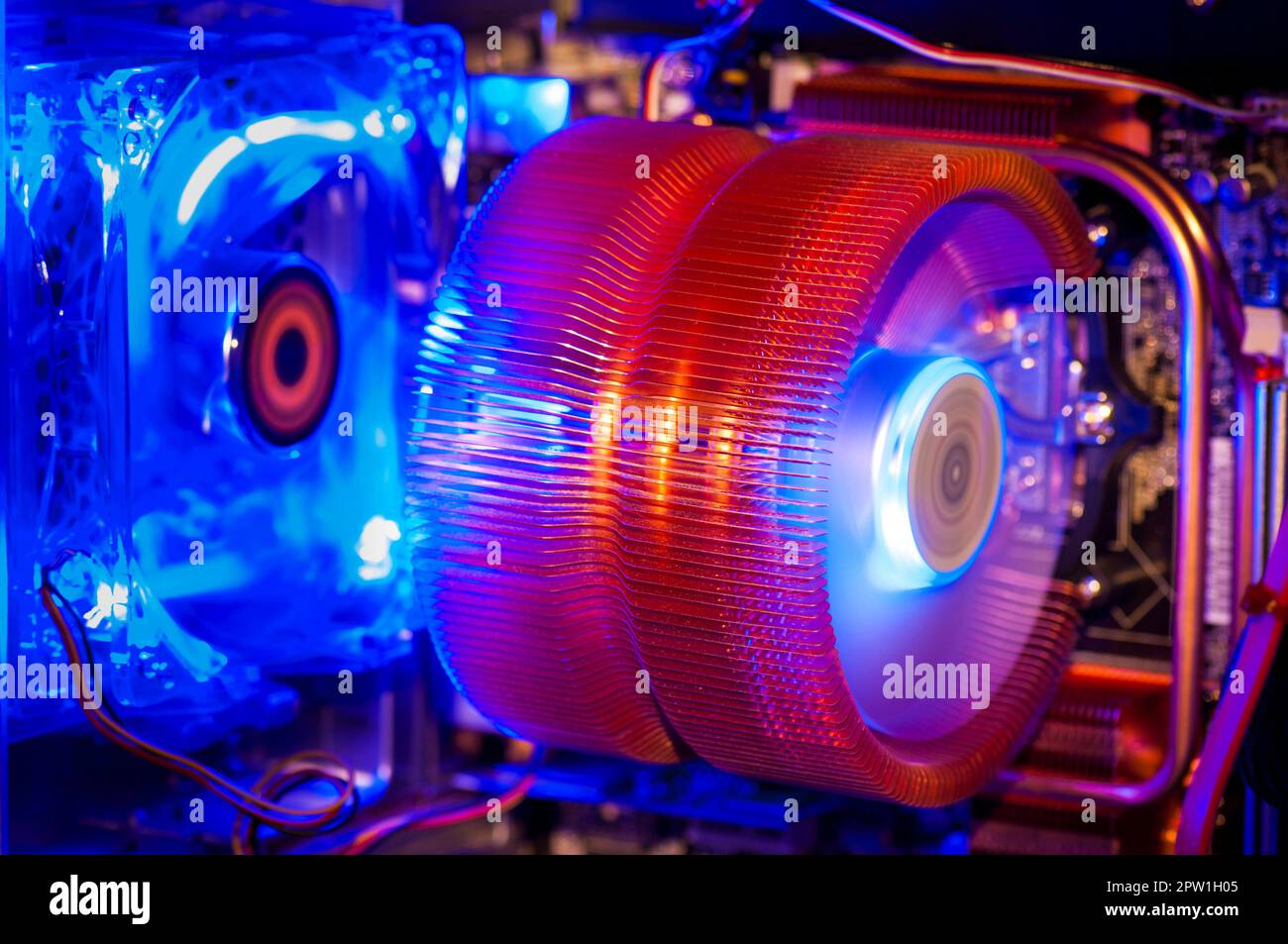 Colorful illuminated fans with cooling fins inside personal computer Stock Photo
