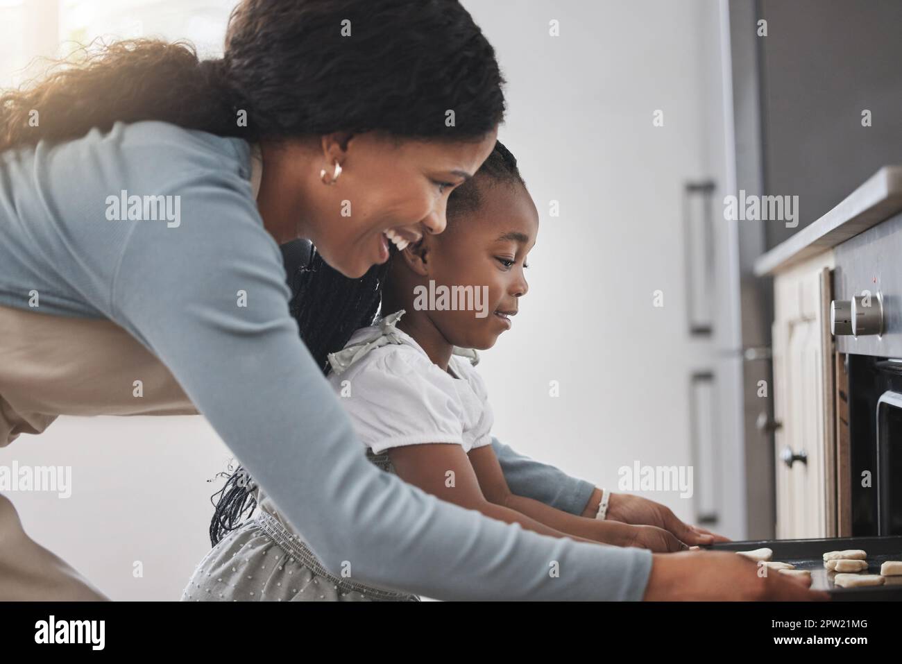 The smell of good cookies baking. a little girl and her mother standing