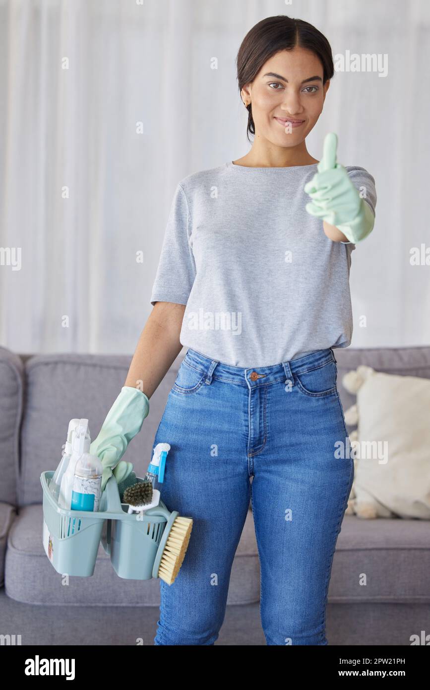 Cleaner, thumbs up and portrait of a woman with supplies to clean the living room of a house. Happy, smile and female maid or housewife with a positiv Stock Photo