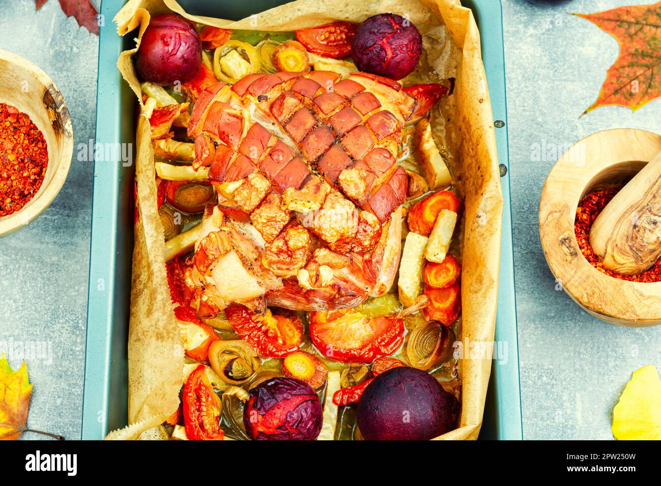 Juicy pork shoulder with skin and bacon fried with vegetables and plums