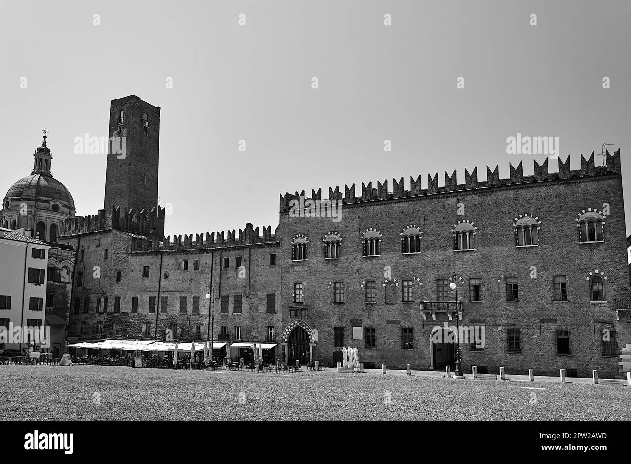 Historic buildings, tables and umbrellas of a restaurant in Piazza