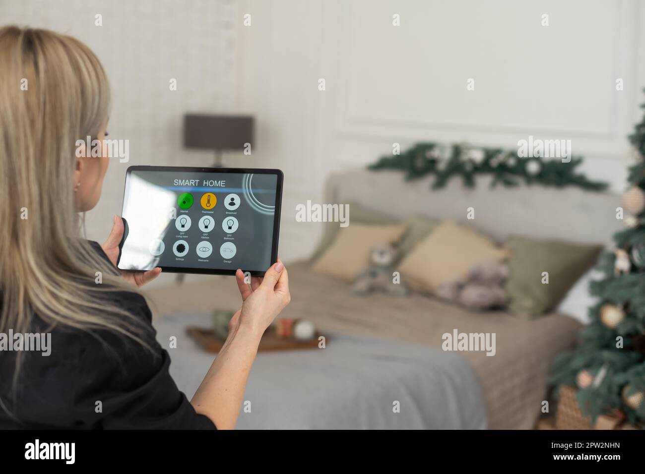 Hand holding a tablet with smart home system applications Stock Photo ...