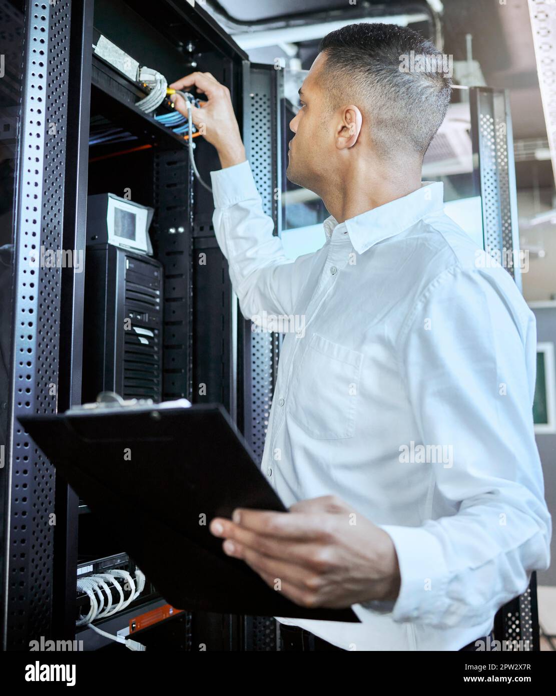 Information technology, server and man engineer with clipboard working, fixing and checking