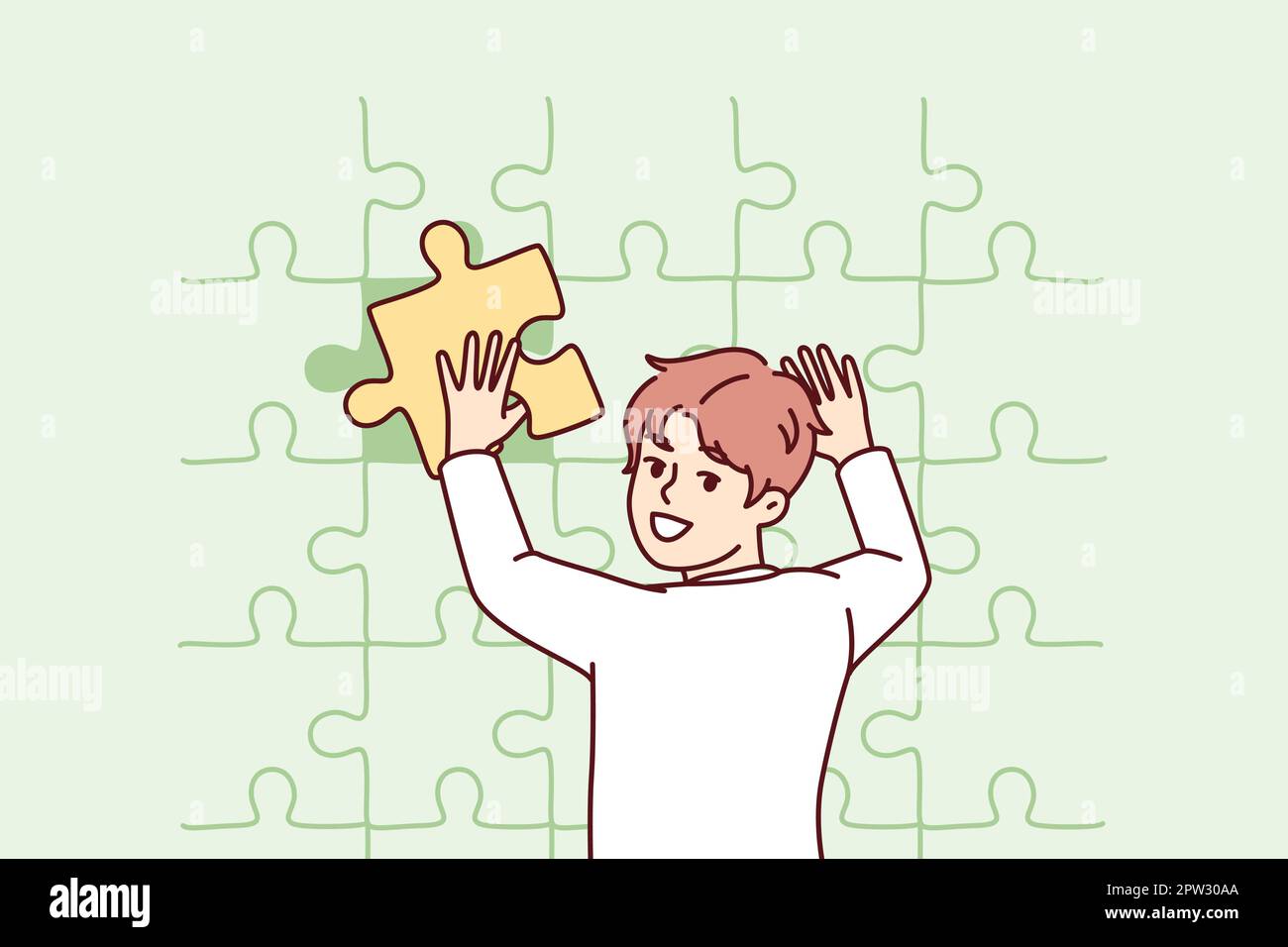 Teenage boy puts together huge puzzle on wall adding missing pieces to