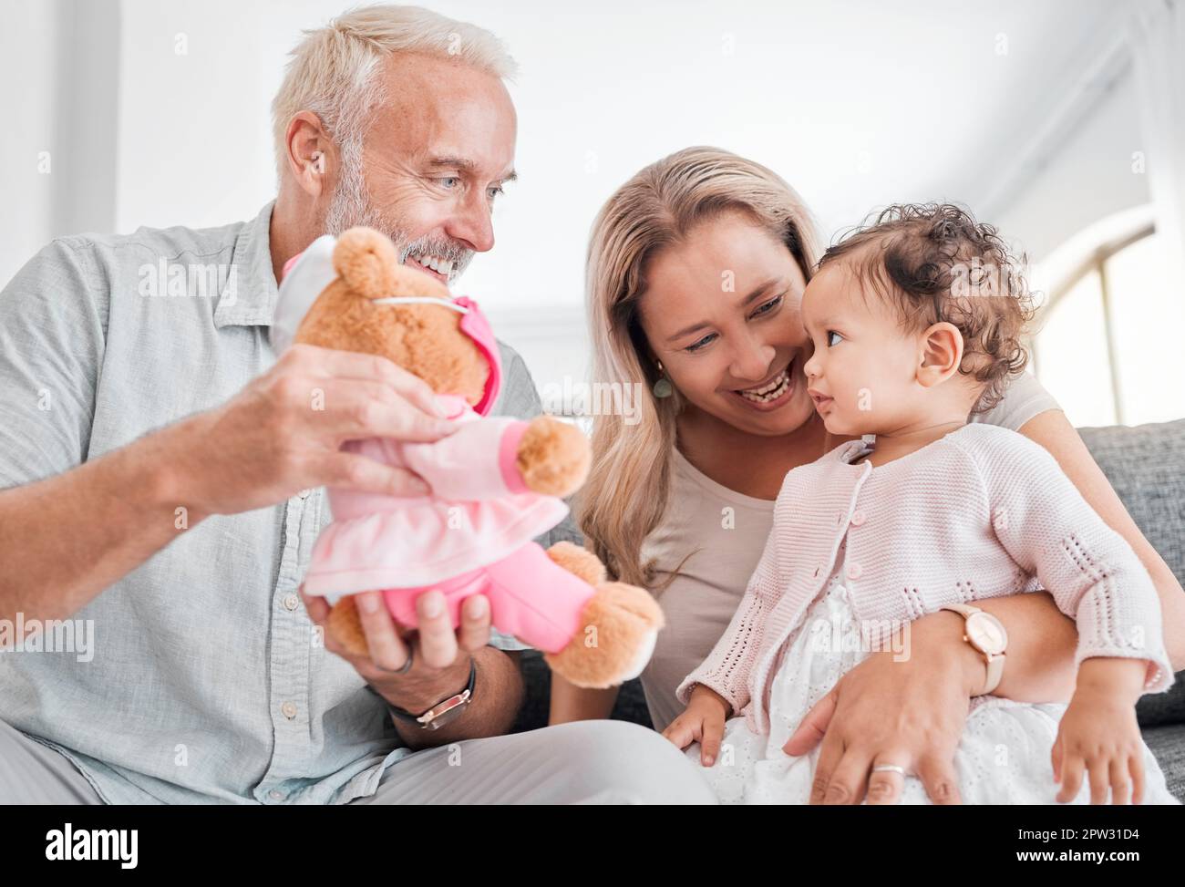 Toy, grandparents and baby play, happy and smile together in family